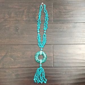 Teal necklace with large ring on bottom